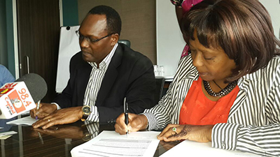 From Left; TMA Kenya Country Director, Dr. Chris Kiptoo and Ms Lucy Karume, Chairperson of the Kenya Tourism Federation, signing the grant agreement.