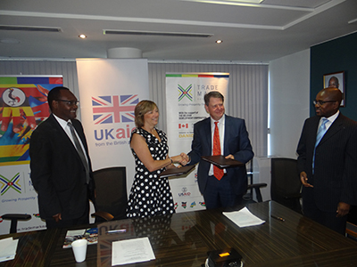 Lisa Phillips, Head of DFID Kenya (Centre) exchanges grant agreement documents with Frank Matsaert, CEO TMA (Left) for additional support to TMA Mombasa Port Program, specifically to support construction of Port Reitz Rd in Mombasa. Looking on is Dr. Chris Kiptoo (right), TMA, Kenya Country Director. 