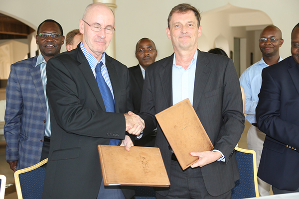 DFID Deputy Head Tom Gardner (left) exchanging grant agreement documents with TMAs Director General David Stanton (right) for funding infrastructure improvements at the Mombasa Port and specifically towards modernization work including infrastructure investments aimed at addressing energy efficiency, speed up import and export trade handling, and minimise environmental impacts at the port of Mombasa