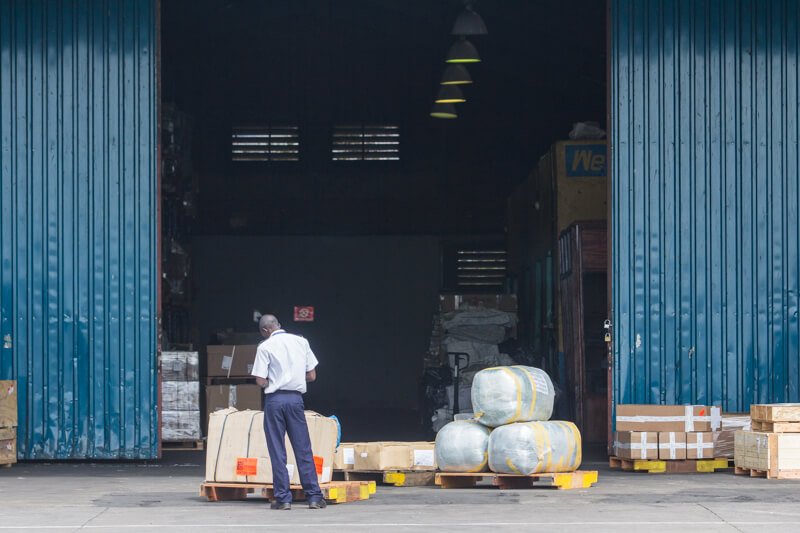 A customs officer at Malaba OSBP inspects goods stored in a bonded warehouse