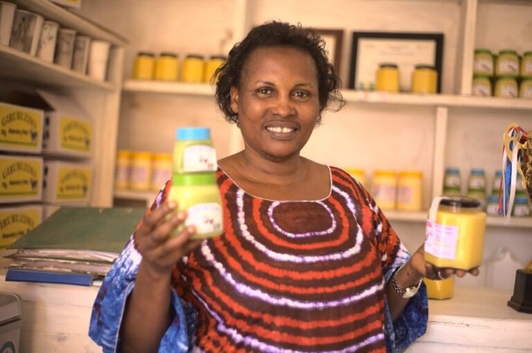 Rosette-Cyarikora-at-a-shop-displaying-her-merchandise_cooperatives-story