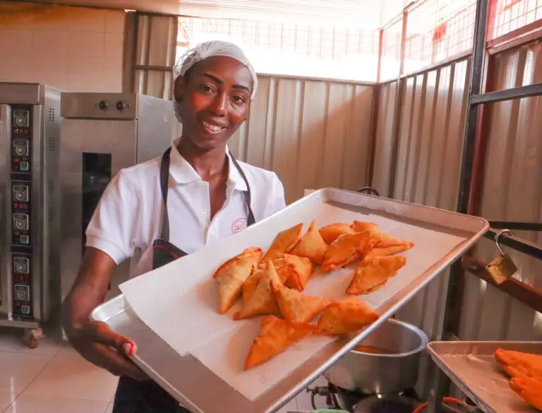 Sandrine Munezero displaying beef samosas at her outlet